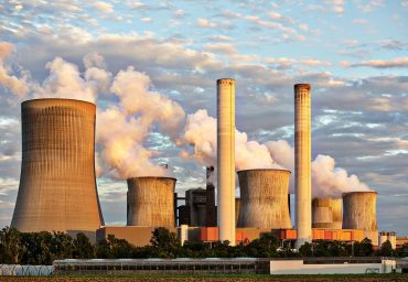 pexels-photo-459728-459728 View of a power plant with smoke emissions under a cloudy sky, depicting industrial energy production.