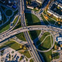 pexels-photo-681335-681335 Aerial shot of a complex highway intersection in a vibrant urban cityscape.